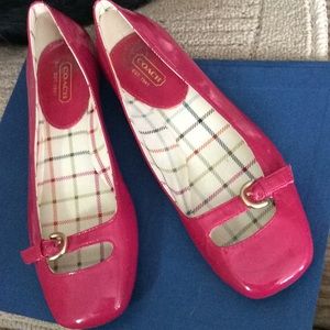 Coach fuchsia patent leather flats with buckle.